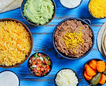 Side Order Bowls including Rice, Salsa, Sour Cream, Guacamole, Beans, Cheese and Spicy Carrots